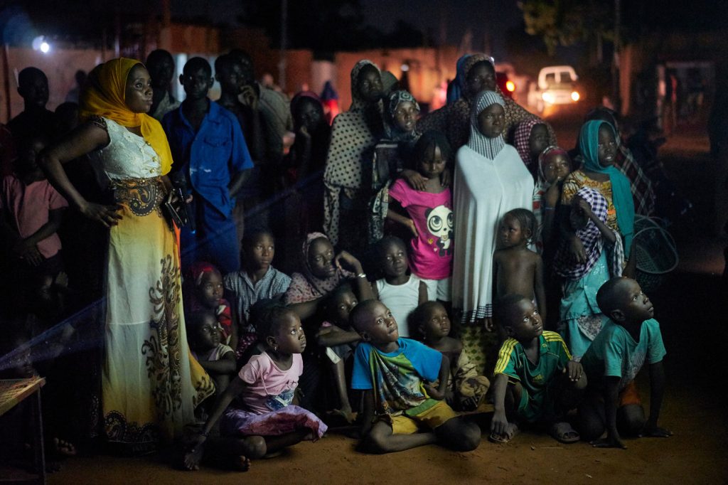 Community members in Niger watch a Mobile Cinema screening