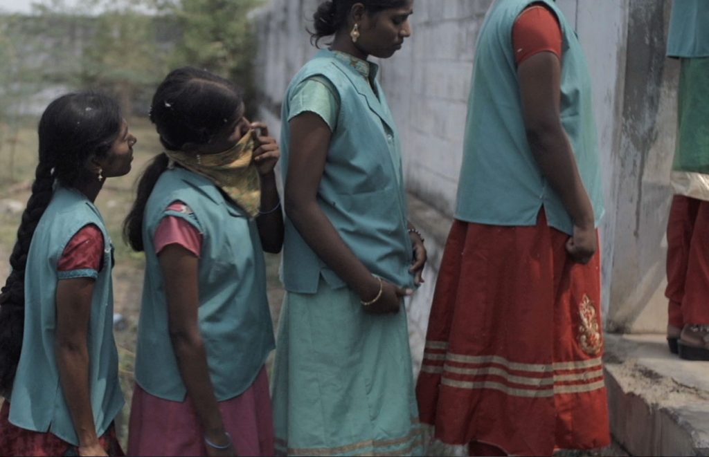 Young girls waiting for the restroom at a cotton mill in southern India