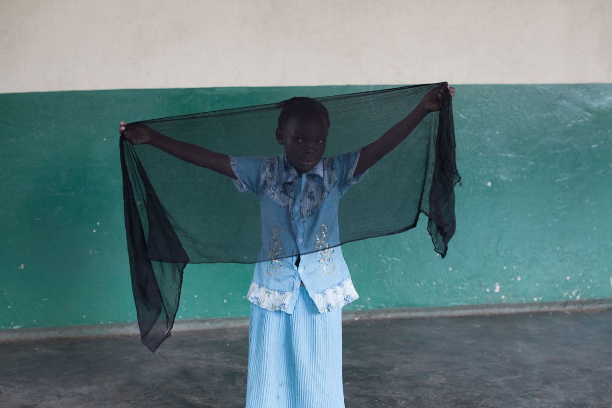 Girl in Bangui, Central African Republic holding a prayer scarf