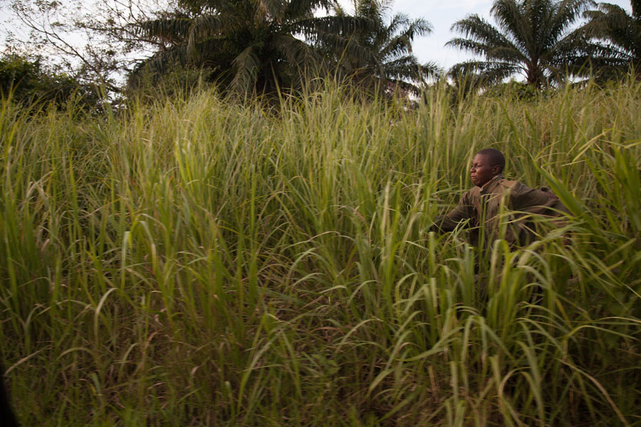 Escaped LRA child soldier runs through the grass, northeastern Democratic Republic of Congo