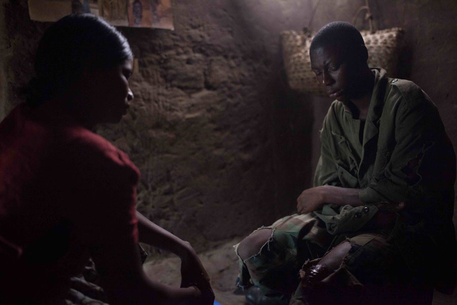 Escaped child soldier from the Lord's Resistance Army receives care for a wounded knee, northeastern Democratic Republic of Congo